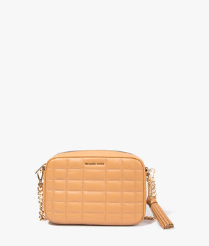 Jet set quilted crossbody bag in pale peanut by Michael Kors. EQVVS WOMEN Front Angle Shot.