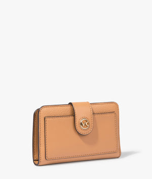 MK charm bifold wallet in pale peanut by Michael Kors. EQVVS WOMEN Side Angle Shot.