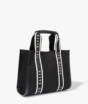 Georjea branded webbing canvas small tote in black by Ted Baker. EQVVS WOMEN Side Angle Shot.