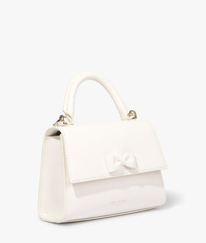 Baelli mini top handle tote in cream by Ted Baker. EQVVS WOMEN Side Angle Shot.