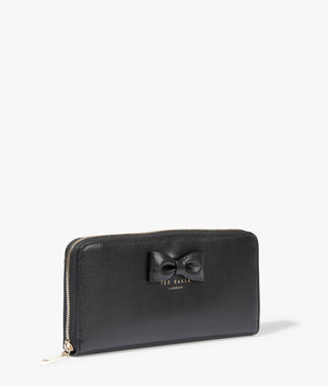 Beyla bow detail zip around purse in black by Ted Baker. EQVVS Side Angle Shot.